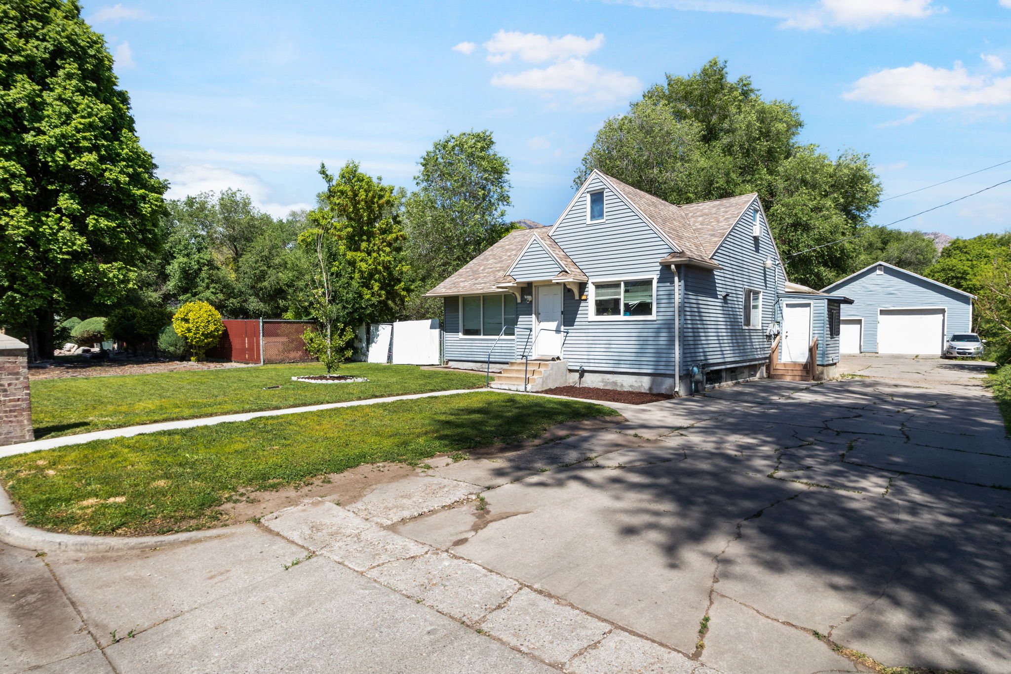 Traditional residence featuring light blue siding and a gabled roofline