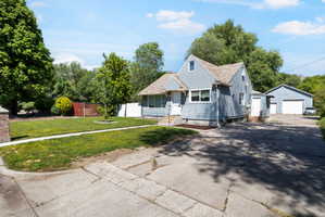 Traditional residence featuring light blue siding and a gabled roofline
