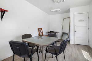 Bright room featuring light wood-finish flooring and white walls