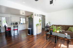 Open-concept living space featuring wood-finish flooring