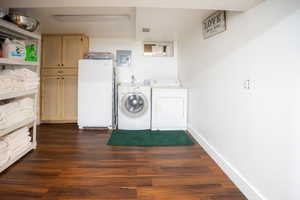 Laundry area featuring wood-finish flooring, white walls, and built-in cabinetry