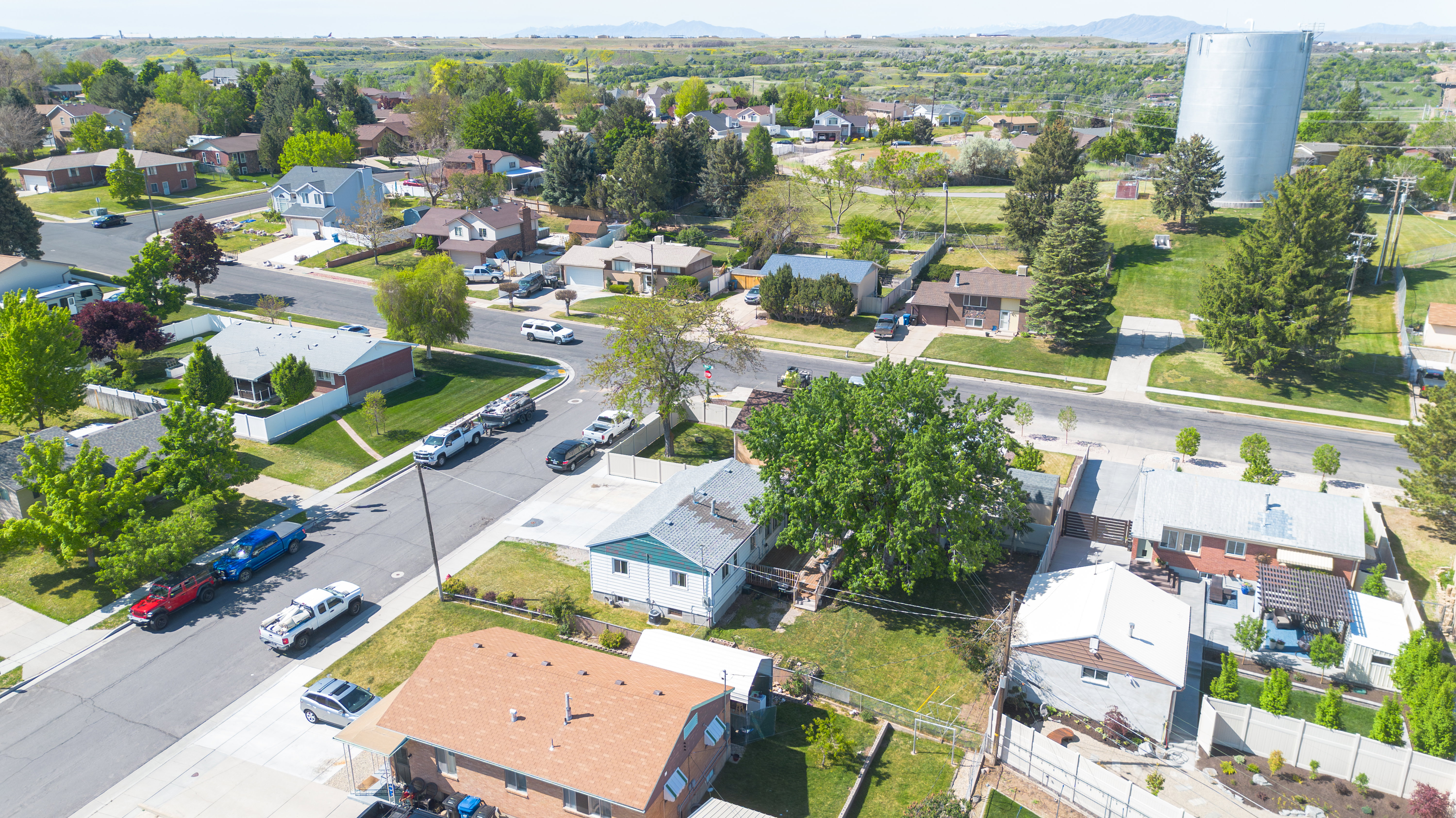 Residential neighborhood featuring mature trees, paved streets, and a variety of architectural styles