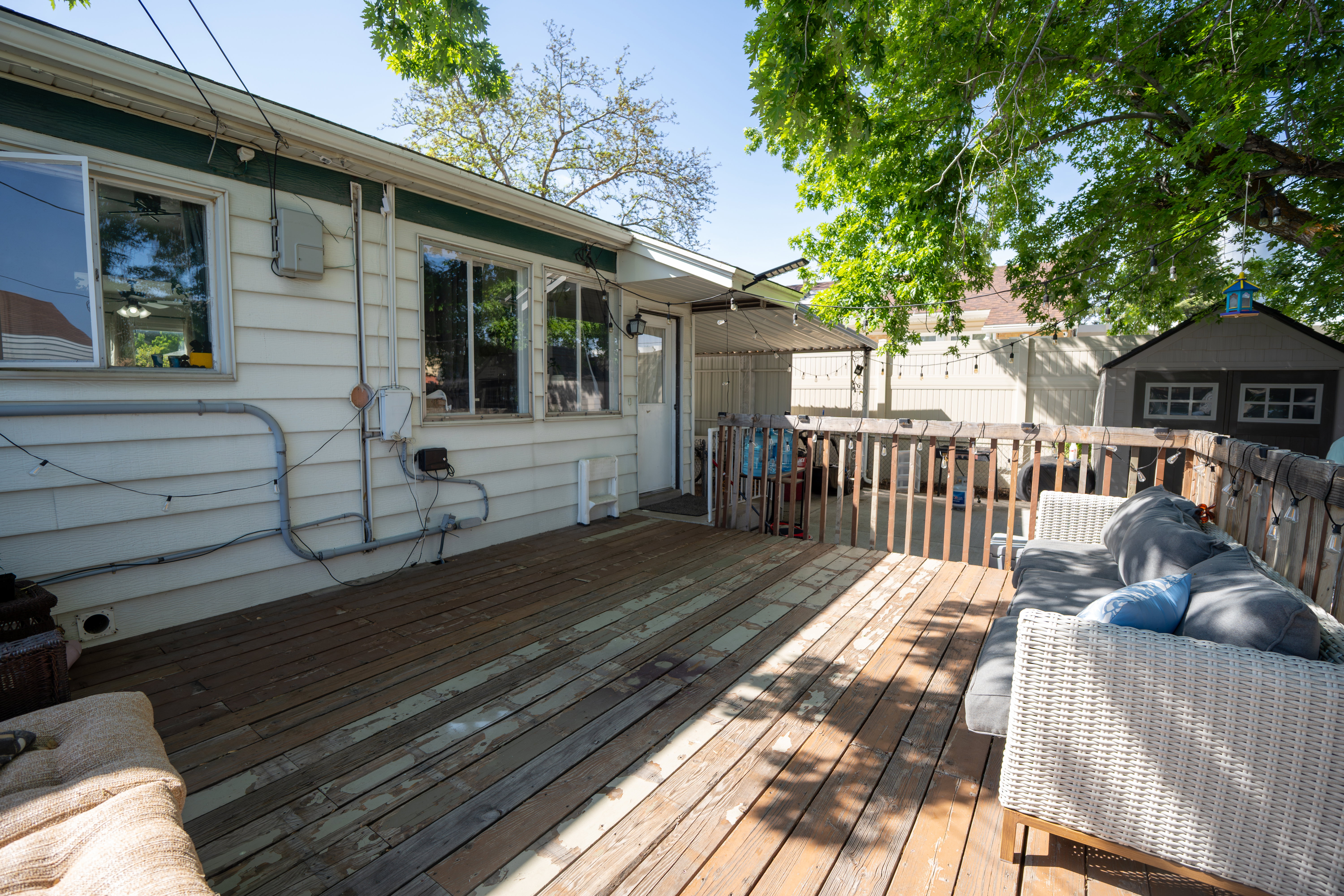Expansive rear deck featuring wood planking and a partial railing