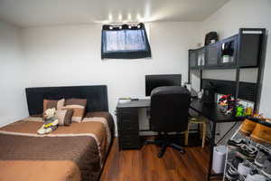 Room featuring wood-finish flooring, a built-in window, and overhead lighting