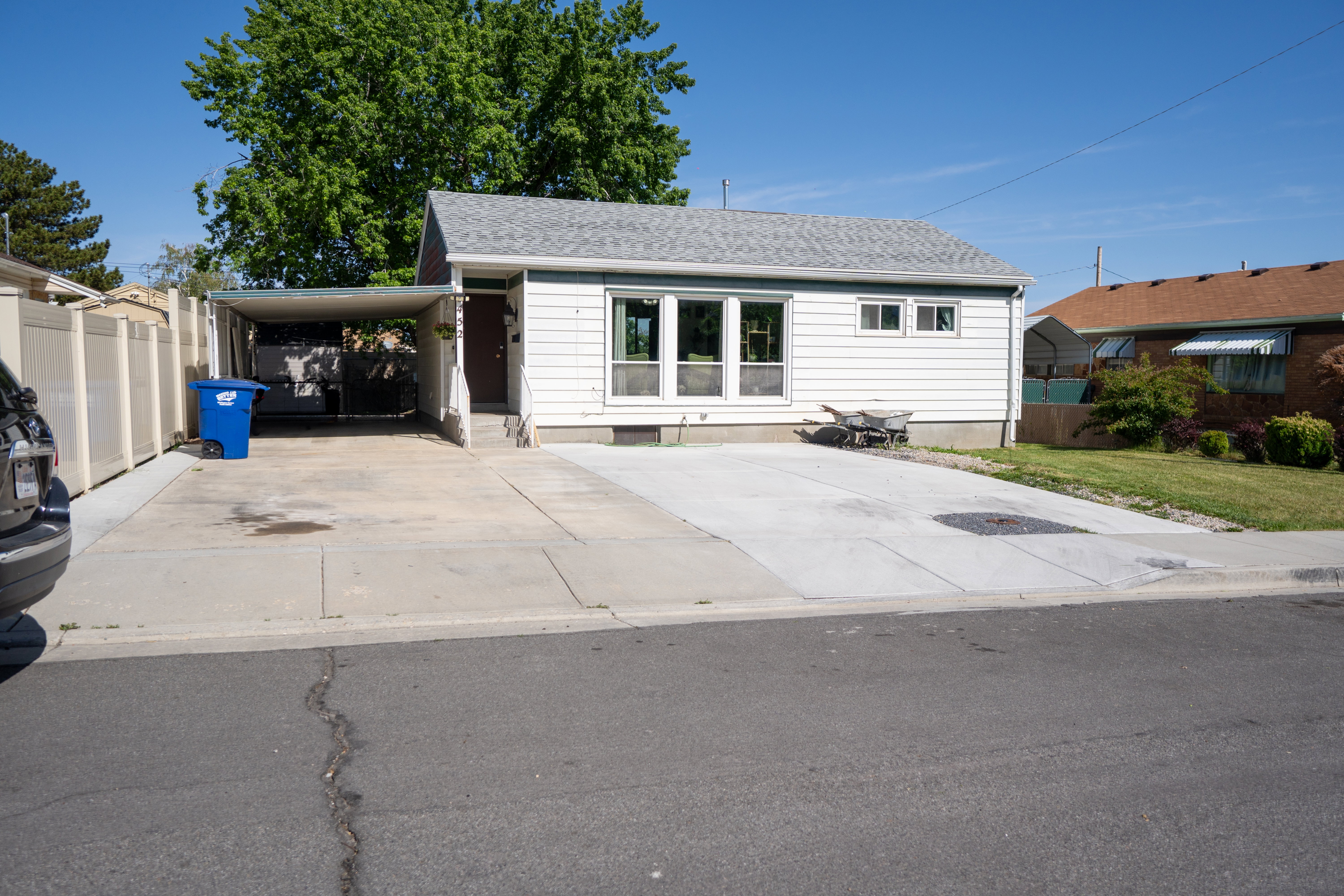 White siding exterior with a light gray shingle roof