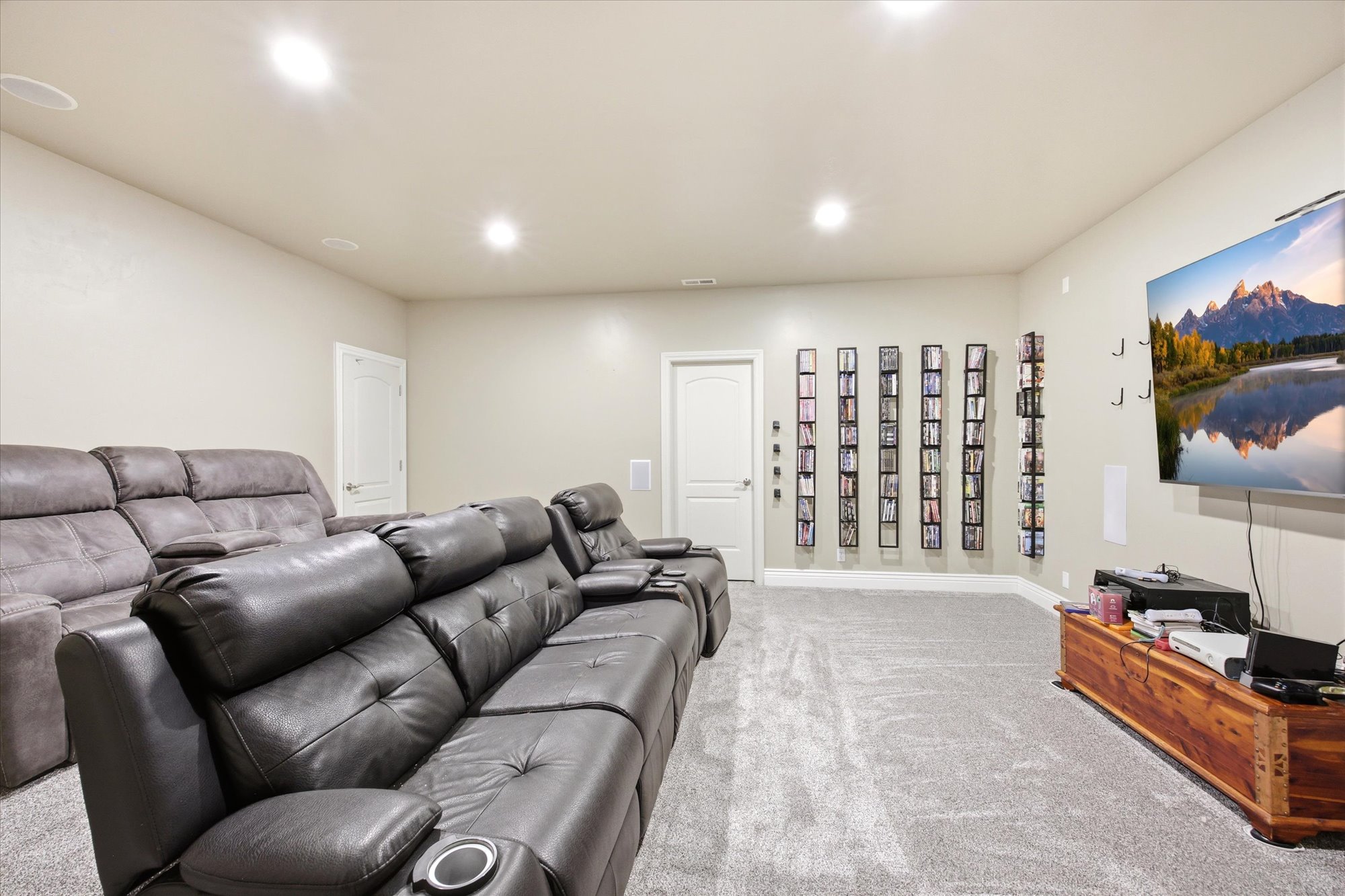 Spacious room with light-toned walls and gray carpeting