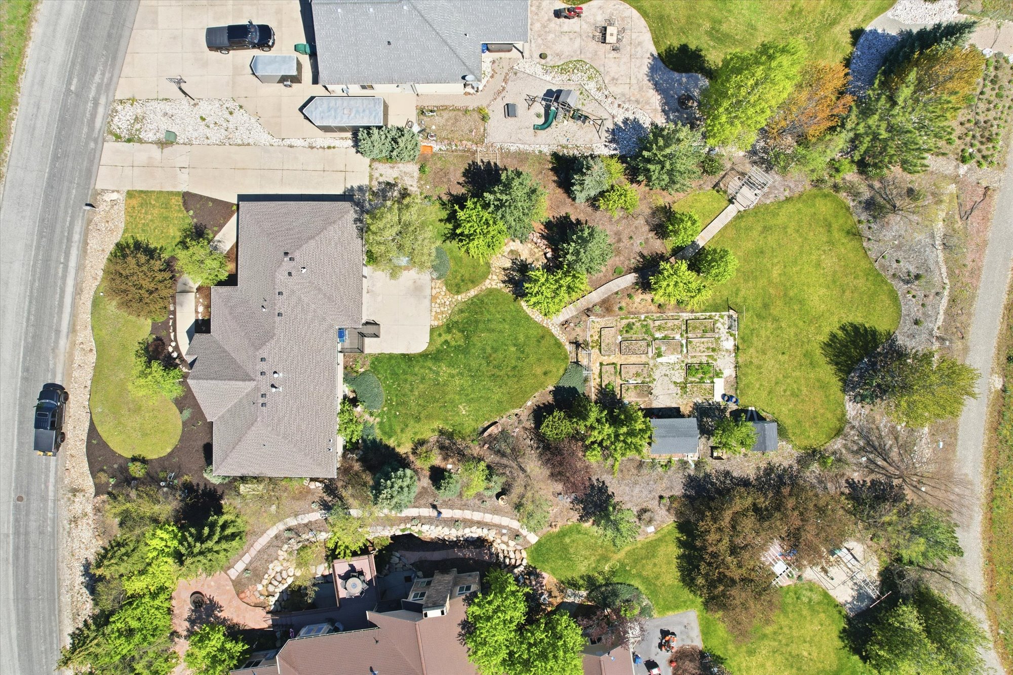 Expansive property featuring a multi-level landscape with mature trees and diverse plantings