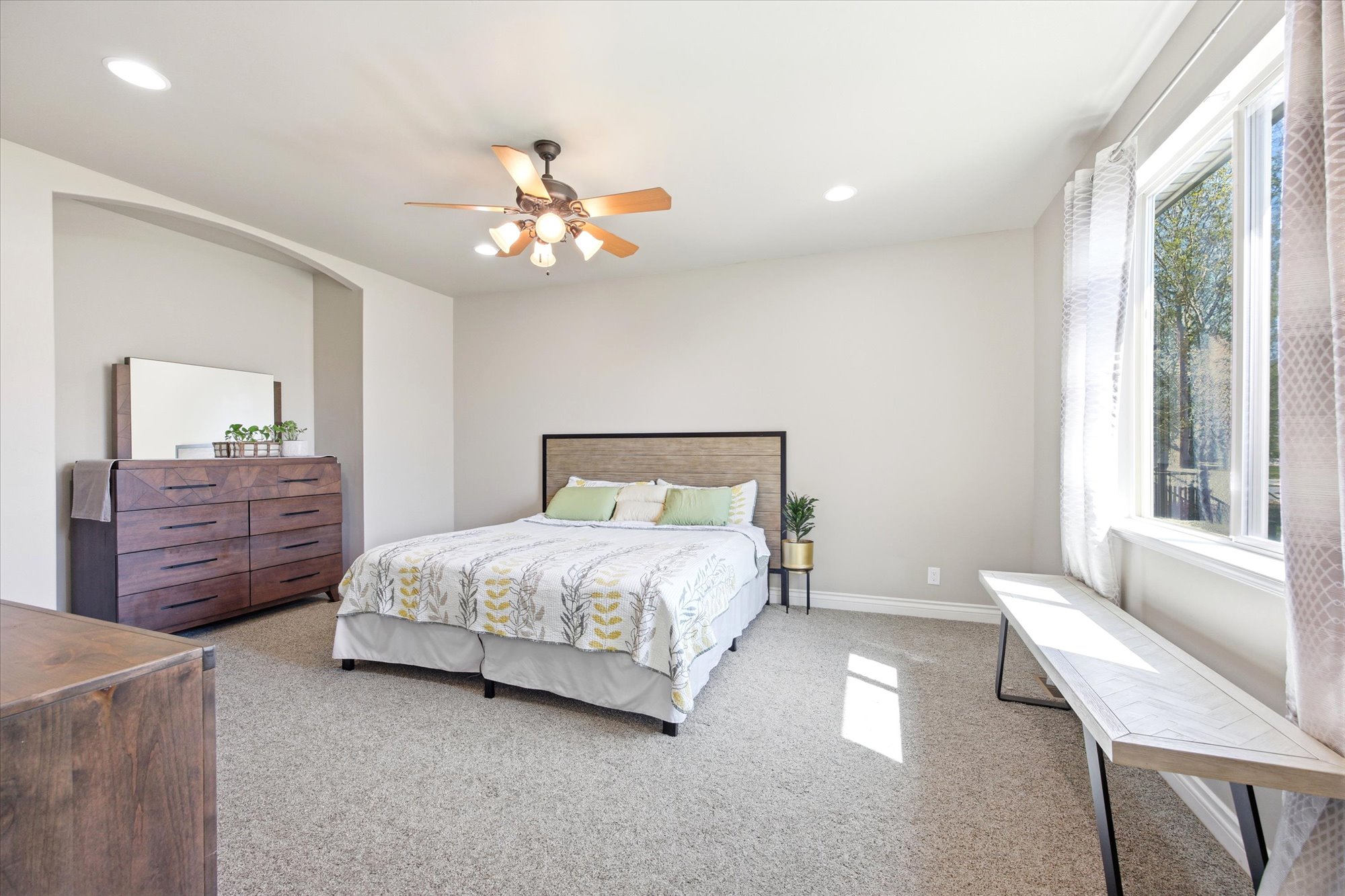 Spacious room featuring neutral carpeting and light-colored walls