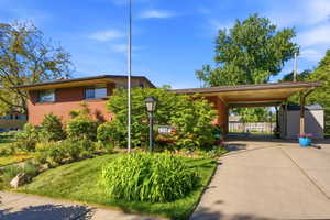 Brick exterior residence with a covered carport and a paved driveway
