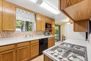 Kitchen featuring wood-finish cabinetry, white countertops, and a mosaic tile backsplash