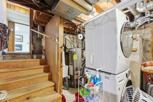 Dedicated laundry area featuring a stacked washer and dryer unit