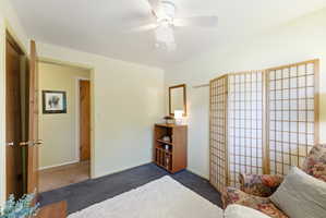 Light-toned wall finishes with a ceiling fan