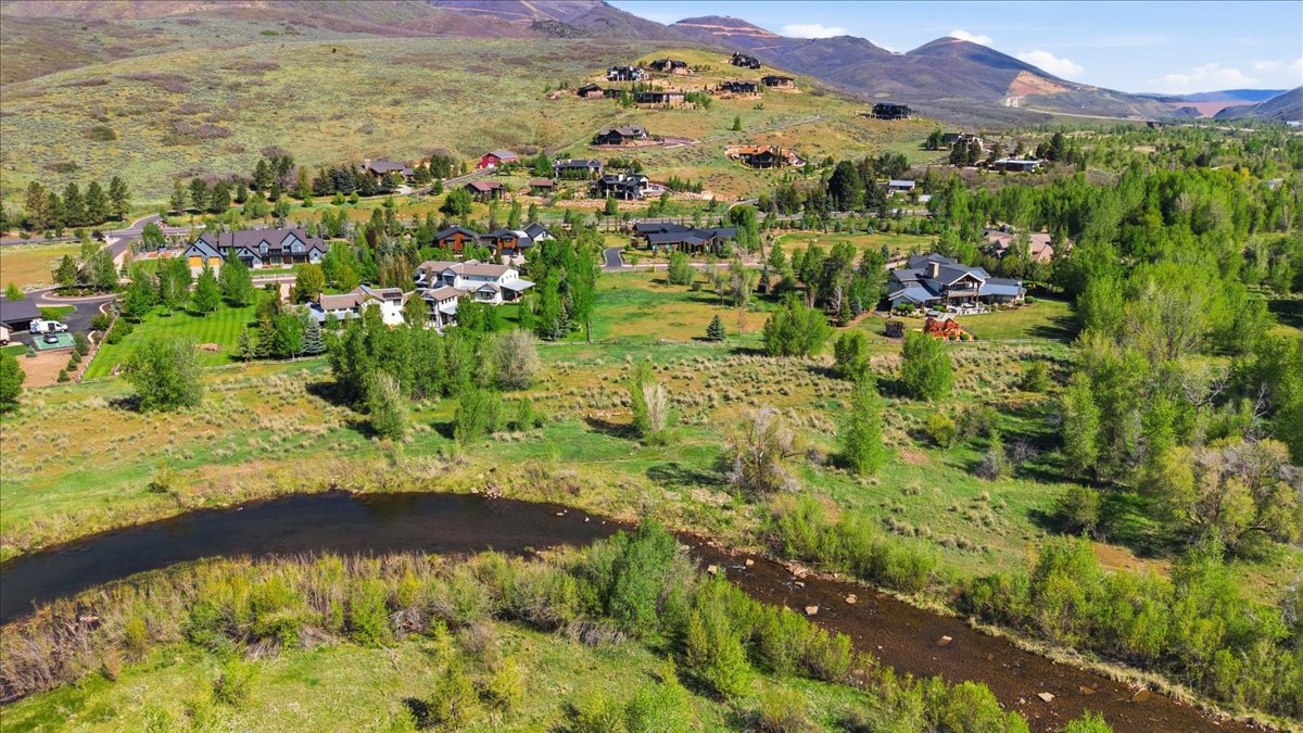 Expansive natural landscape featuring a winding river and lush green foliage