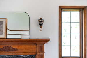 Ornate wood fireplace mantel with carved detailing