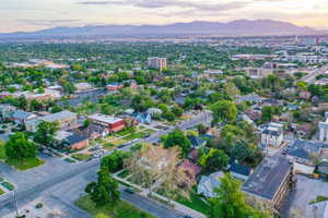 Expansive aerial perspective showcasing a residential and commercial area with distant mountains