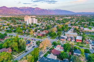 Expansive neighborhood setting featuring a variety of architectural styles, mature trees, and broad streets