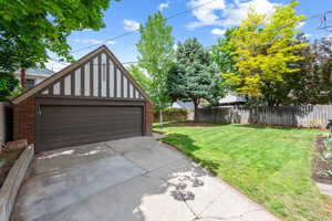 Detached garage with Tudor-style gabled roofline and brick lower exterior