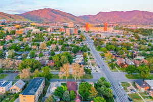 Aerial perspective showcasing an urban landscape with a prominent mountain range backdrop