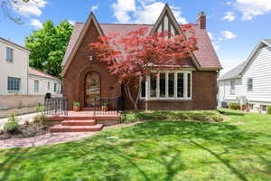 Brick exterior featuring a steeply pitched roofline with gables