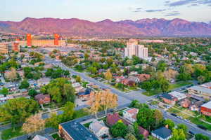 Expansive neighborhood setting featuring a mix of residential structures and mature trees