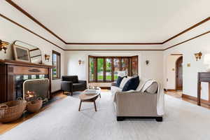 Living space featuring a wood-finish fireplace with dark stone surround, bay windows, and archway entry