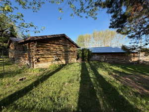 Two rustic log structures with metal roofing