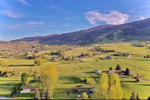 Expansive green landscape featuring rolling hills and distant mountains