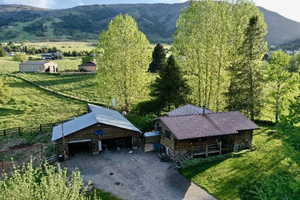 Rustic cabin-style residence featuring a metal roof and an elevated porch