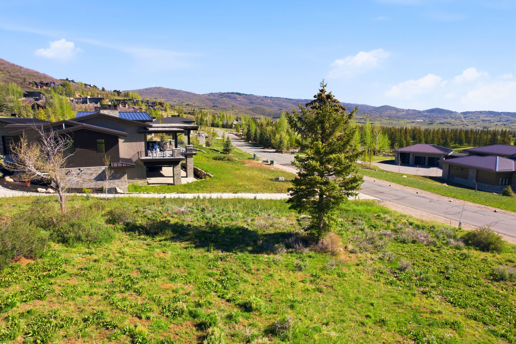 Modern architecture featuring a dark-toned exterior with stone accents and a multi-level design