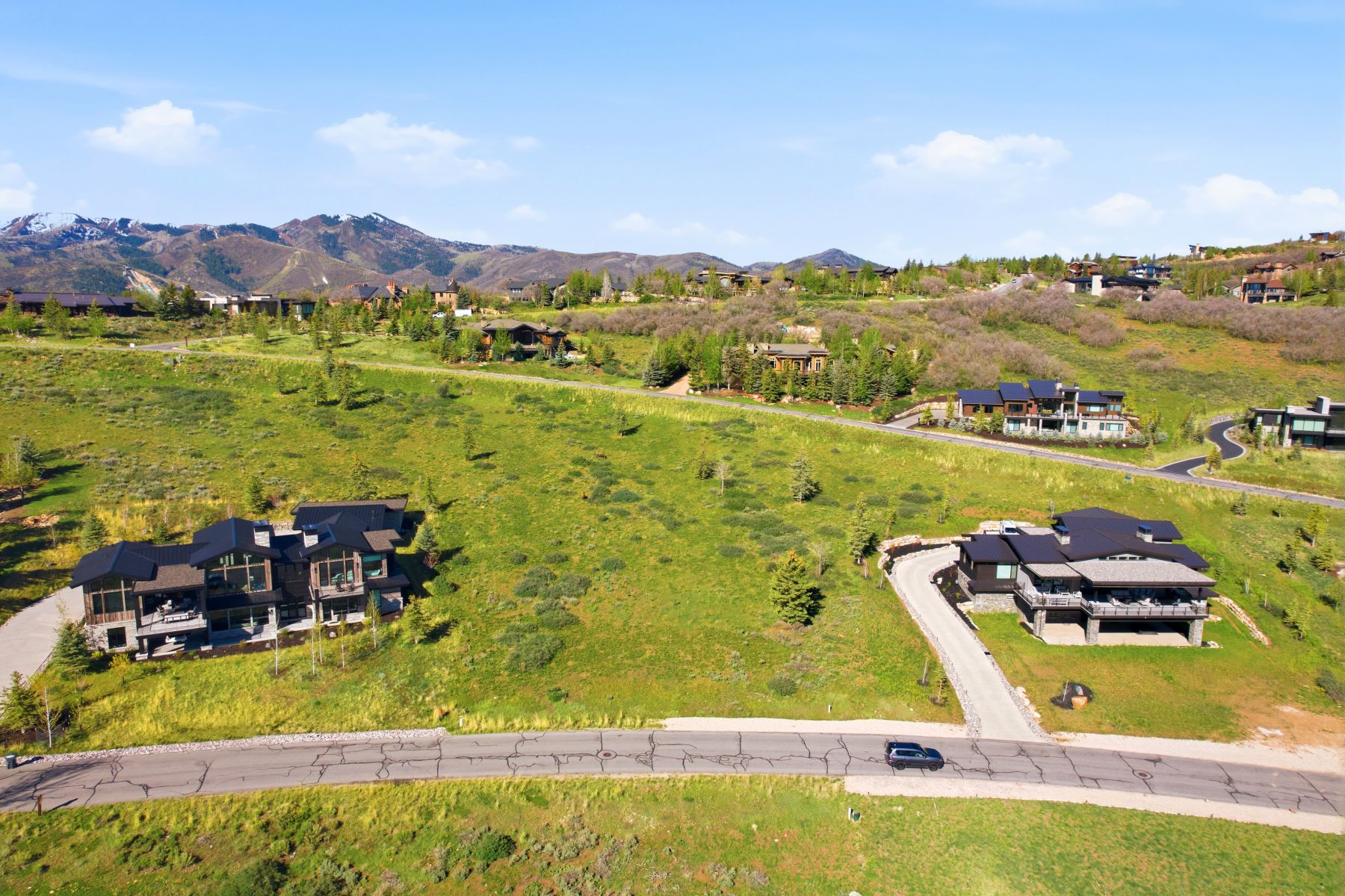 Expansive mountain landscape featuring varied terrain and multiple custom-built properties