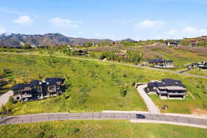 Expansive mountain landscape featuring varied terrain and multiple custom-built properties