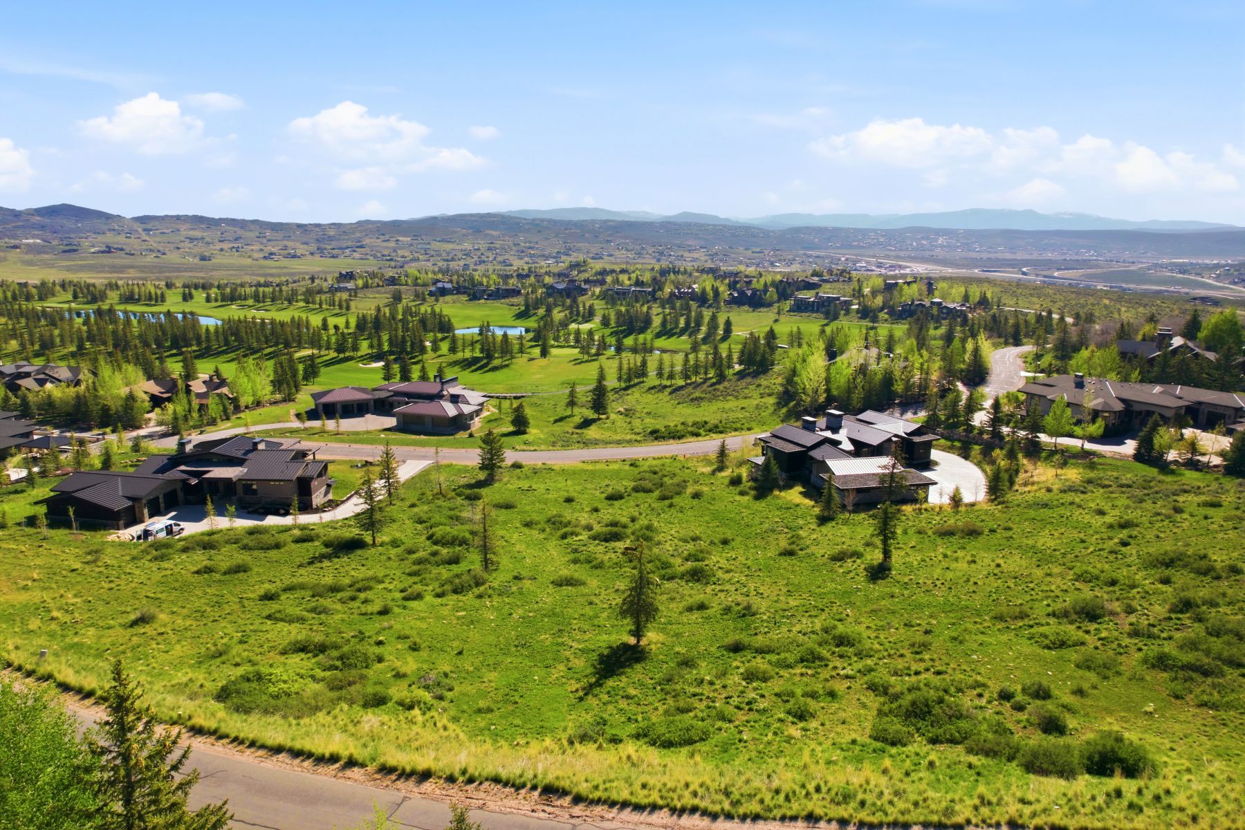 Expansive green terrain with distant mountain ranges