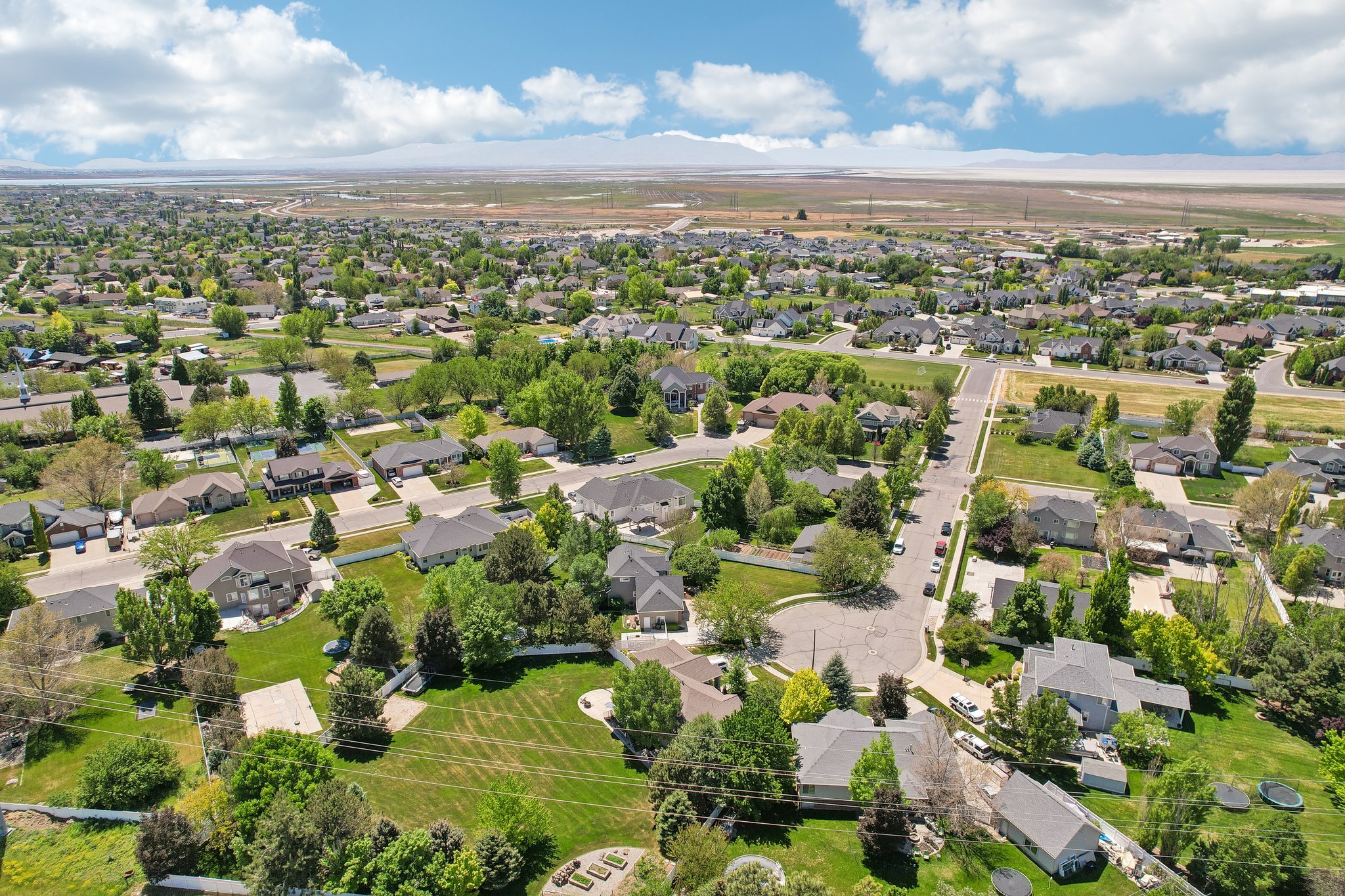 Expansive residential neighborhood featuring numerous detached single-family homes, mature trees, and paved streets