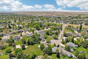Expansive residential neighborhood featuring numerous detached single-family homes, mature trees, and paved streets