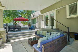 Covered patio featuring a concrete slab and a tiered composite deck