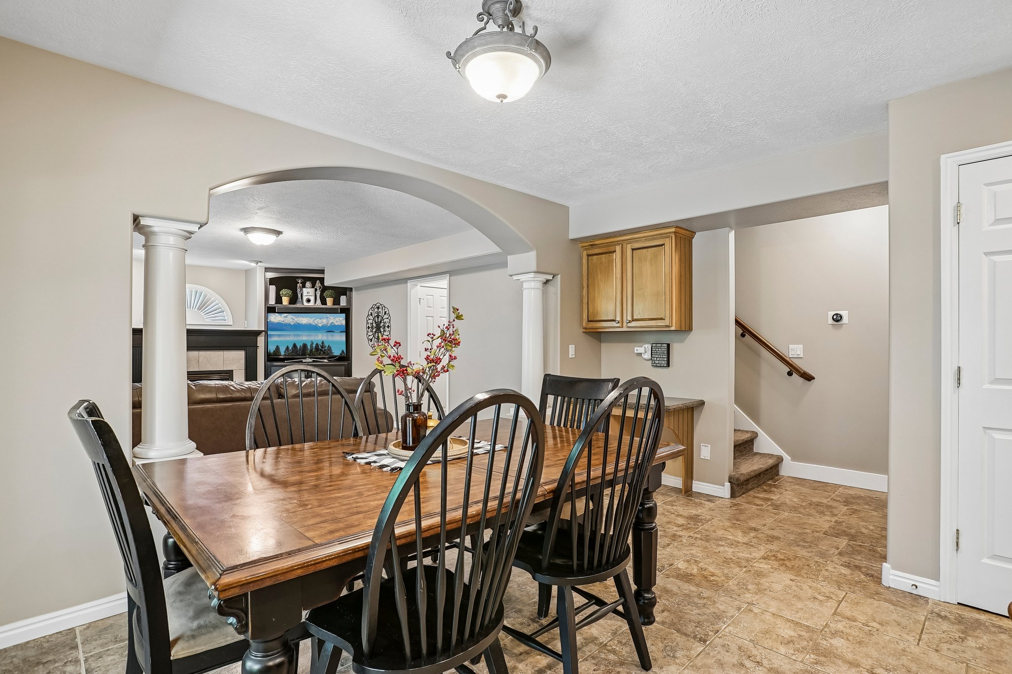Spacious dining area featuring neutral wall tones and tile flooring