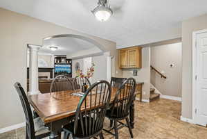 Spacious dining area featuring neutral wall tones and tile flooring