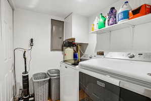 Dedicated laundry area featuring white wall paneling, built-in shelving, and a water filtration system