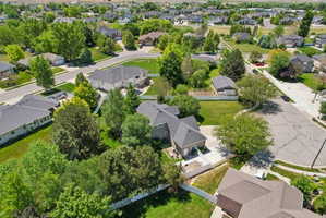Residential neighborhood featuring mature trees and established homes with dark roofs