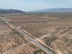 View of rural area featuring a mountain backdrop and a desert landscape