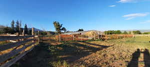 View of yard with a view of countryside, an outbuilding, a mountain view, and an exterior structure