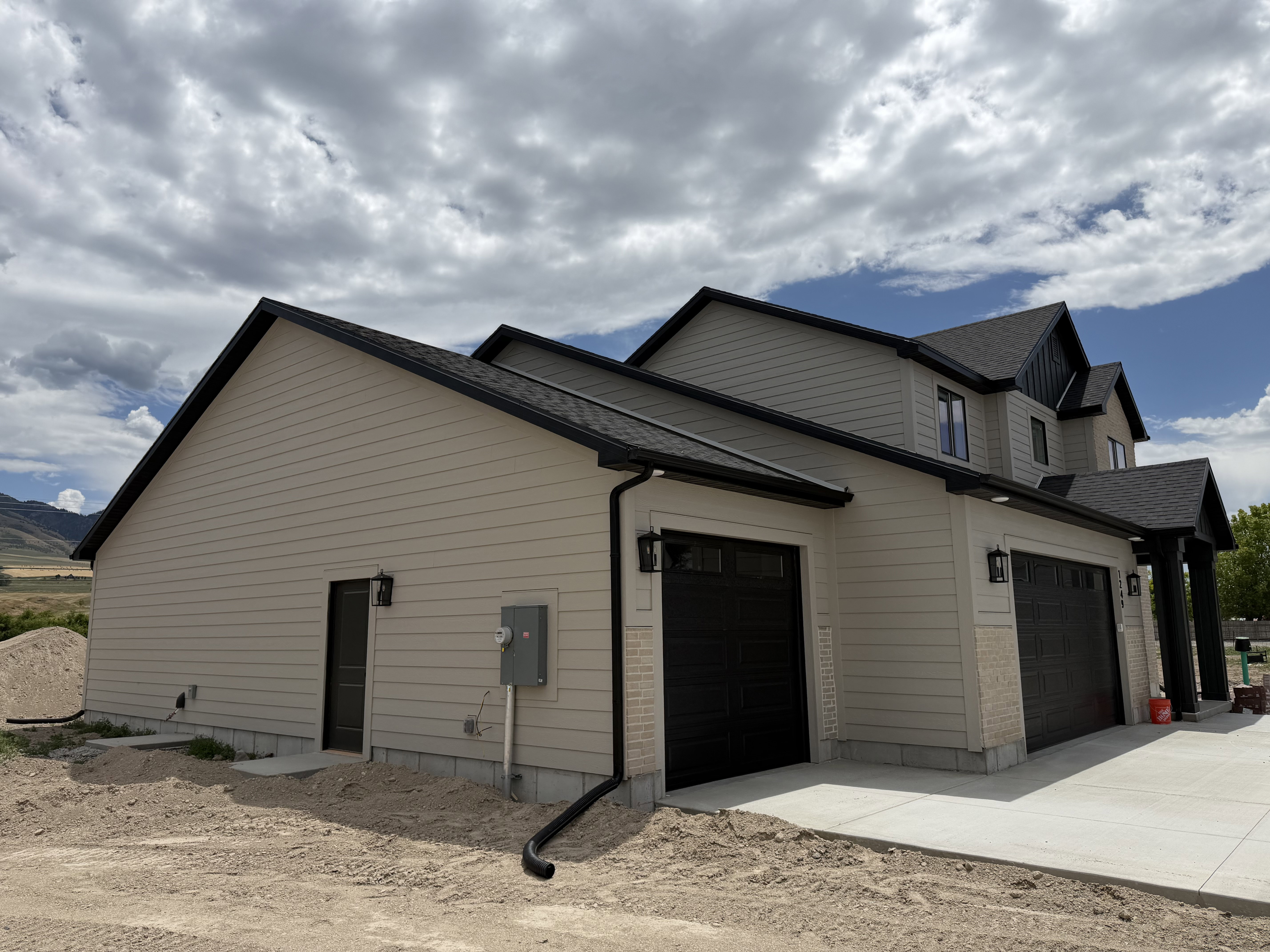 Contemporary residence with light beige horizontal siding and black trim accents