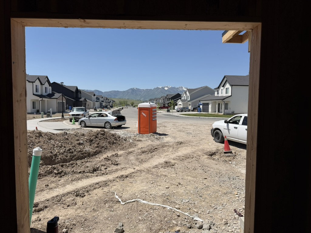 Developing neighborhood with a paved street, curb, and sidewalks