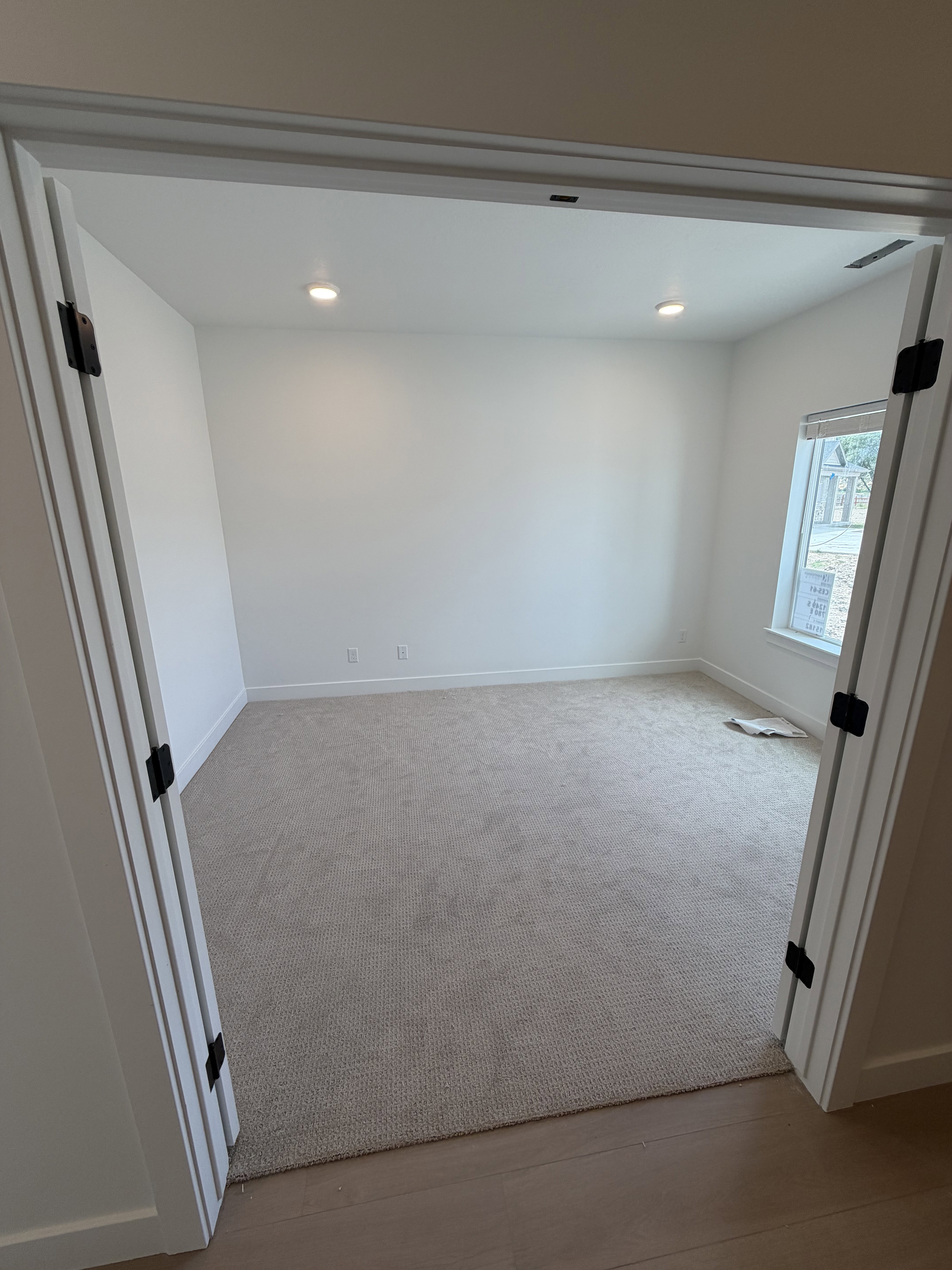 Room featuring neutral tone carpeting and white walls