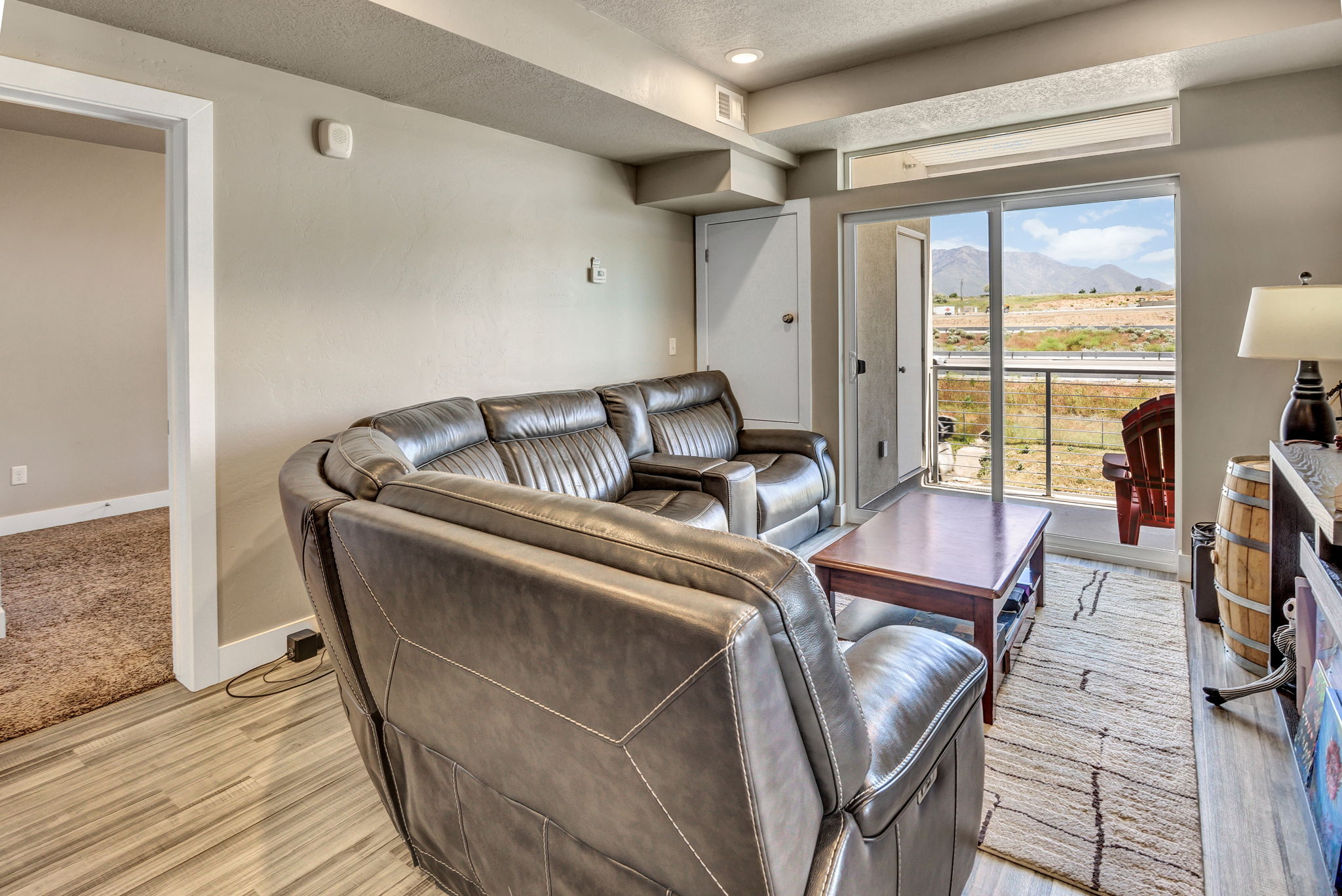 Living area featuring wood-finish flooring and a sliding glass door