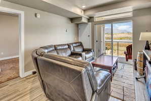 Living area featuring wood-finish flooring and a sliding glass door