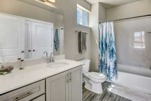 Bathroom featuring a vanity with an integrated sink, light-toned countertop, and light gray cabinetry