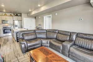 Open-concept living area featuring wood-finish flooring and recessed lighting