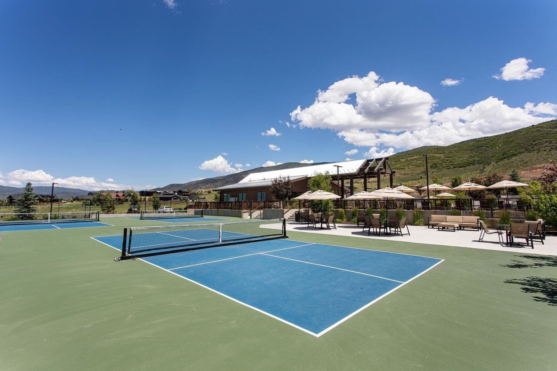 Multiple outdoor courts with blue and green surfacing