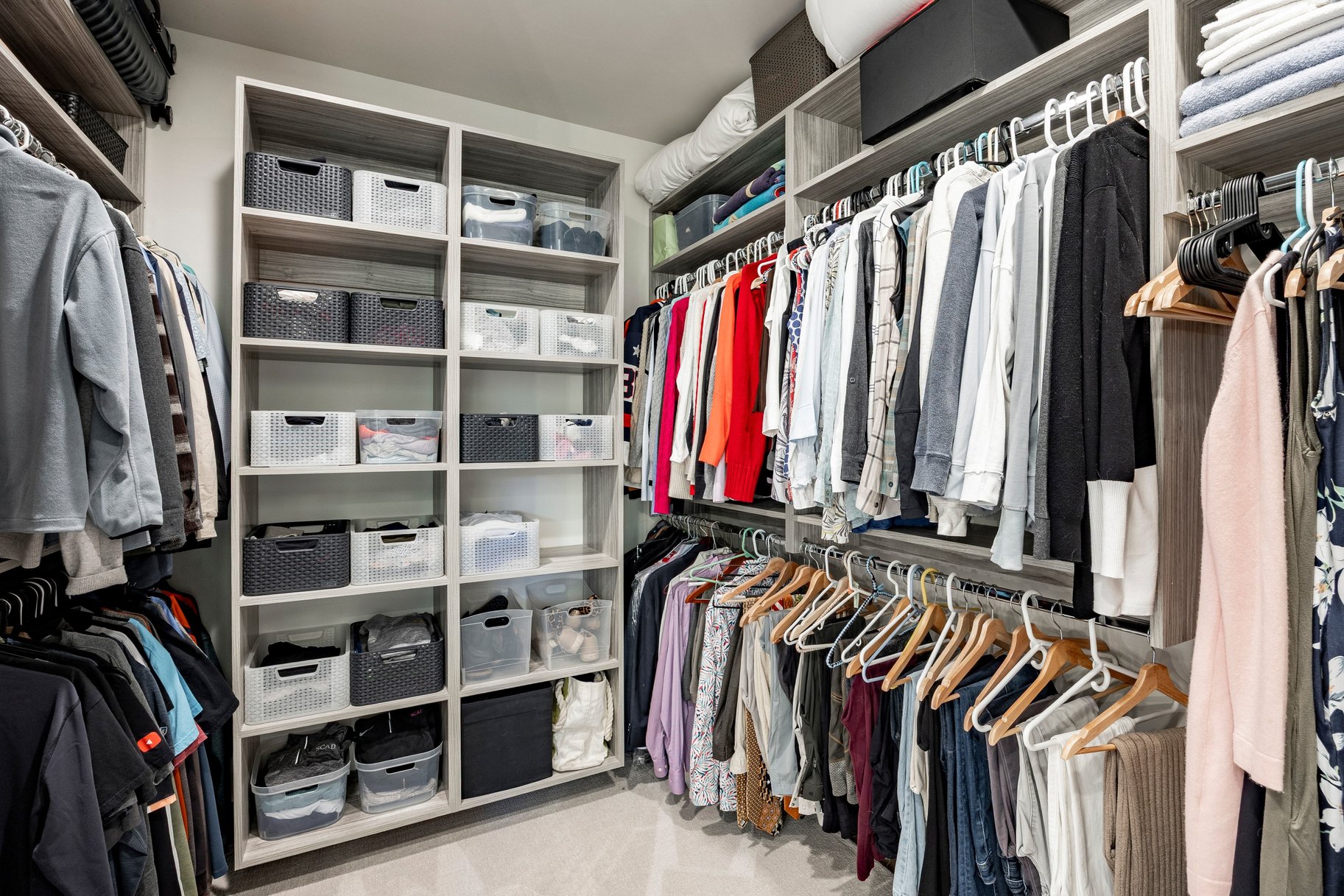 Custom closet system featuring extensive shelving and hanging rods